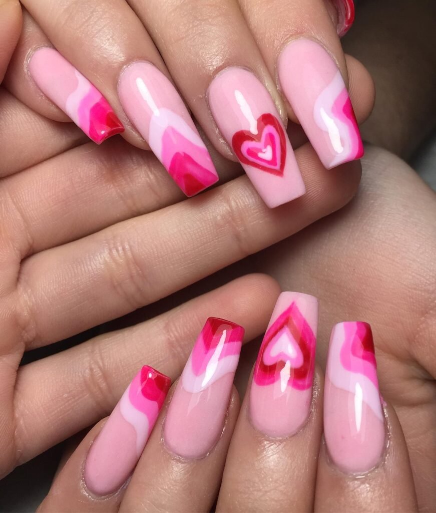 Classic Valentine’s Day nails featuring red and pink heart designs with a glossy finish for a romantic touch