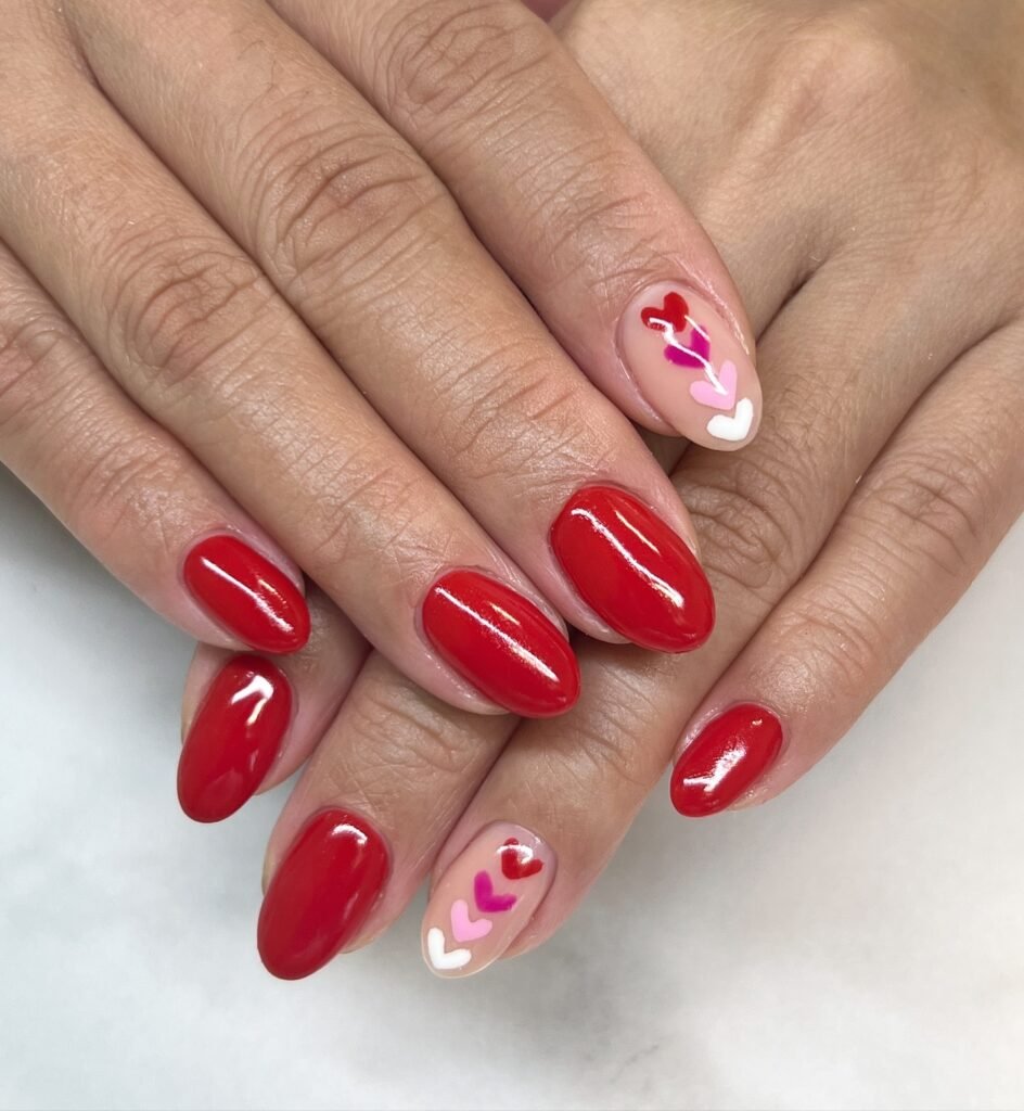 Classic Valentine’s Day nails featuring red and pink heart designs with a glossy finish for a romantic touch