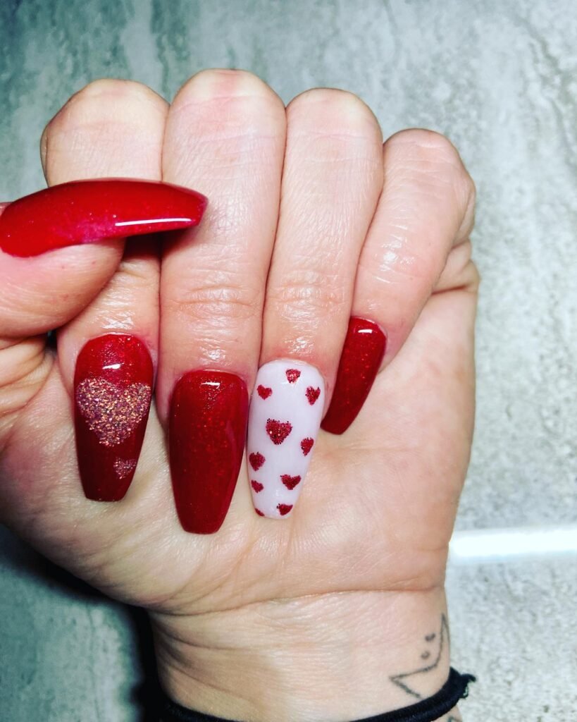 Classic Valentine’s Day nails featuring red and pink heart designs with a glossy finish for a romantic touch