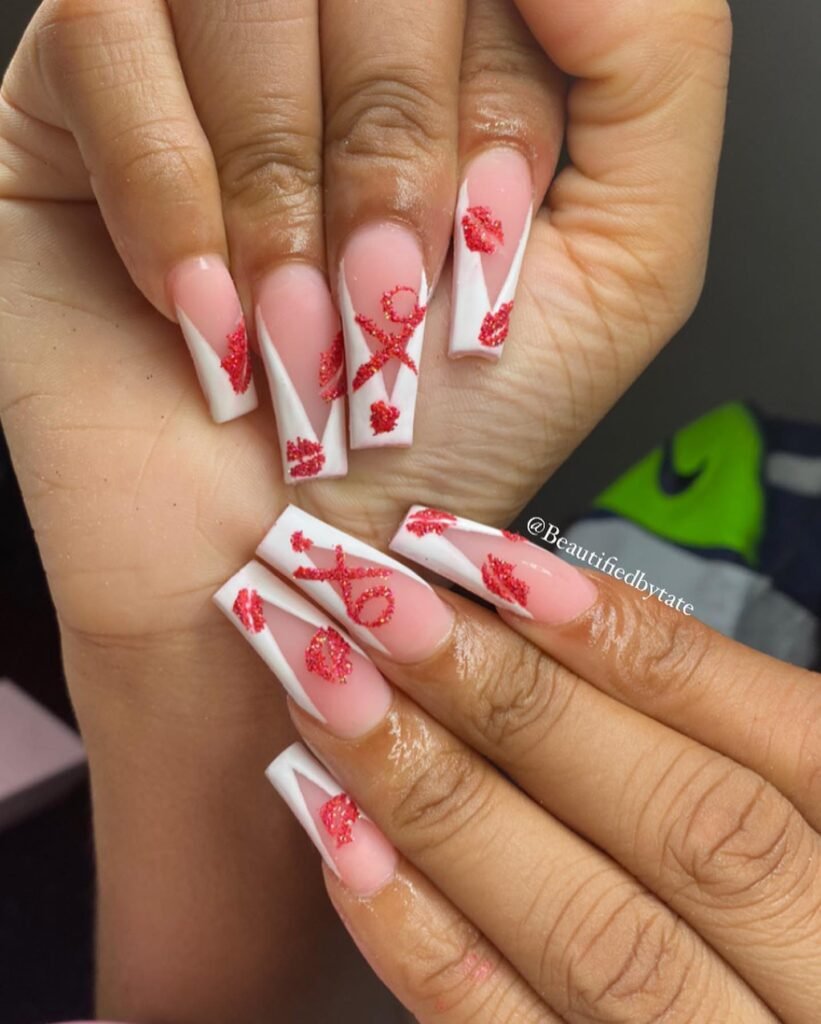 Classic Valentine’s Day nails featuring red and pink heart designs with a glossy finish for a romantic touch