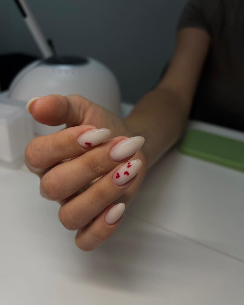 Classic Valentine’s Day nails featuring red and pink heart designs with a glossy finish for a romantic touch