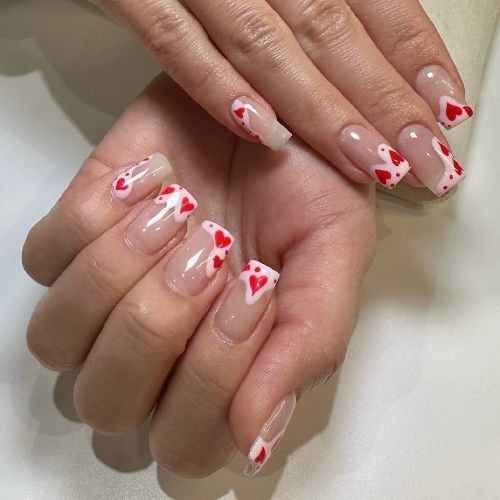 Classic Valentine’s Day nails featuring red and pink heart designs with a glossy finish for a romantic touch