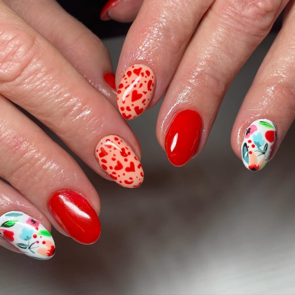 Classic Valentine’s Day nails featuring red and pink heart designs with a glossy finish for a romantic touch