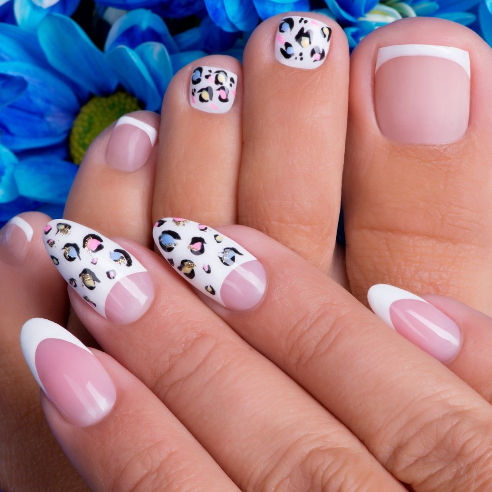 Elegant summer nails with vibrant pink and blue flower designs, featuring acrylic 3D flowers on a glossy white base, perfect for spring and summer fashion.