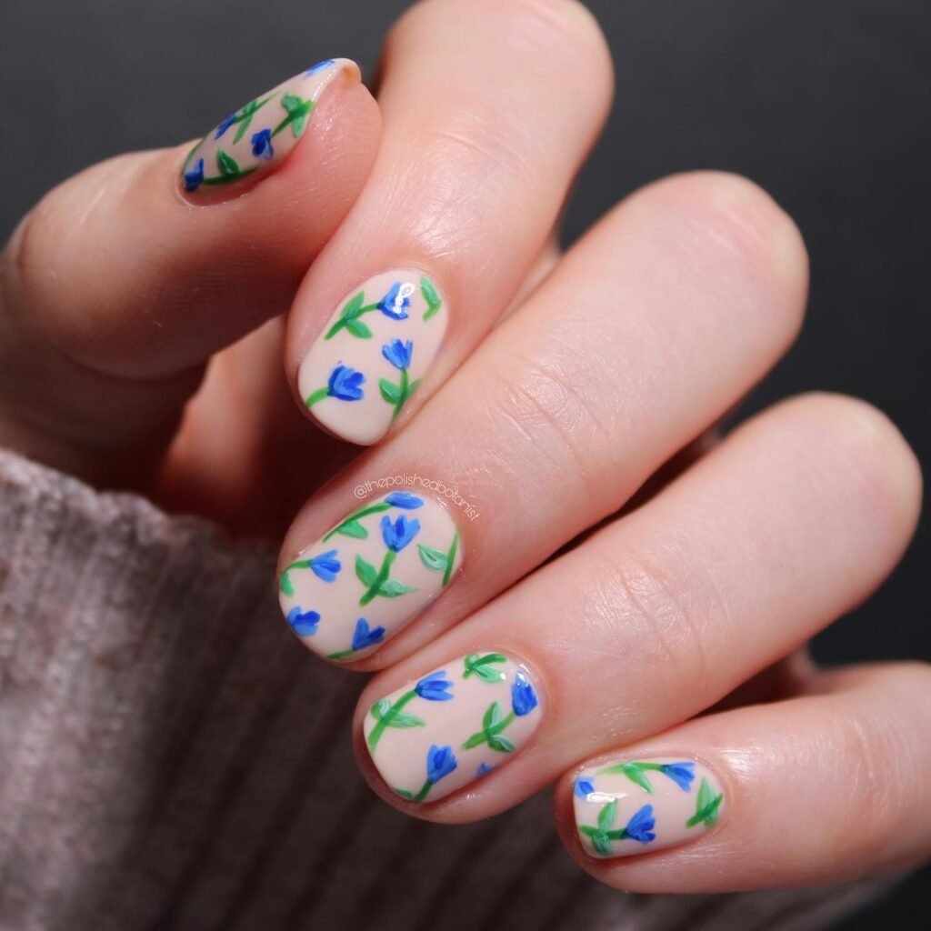 Elegant summer nails with vibrant pink and blue flower designs, featuring acrylic 3D flowers on a glossy white base, perfect for spring and summer fashion.