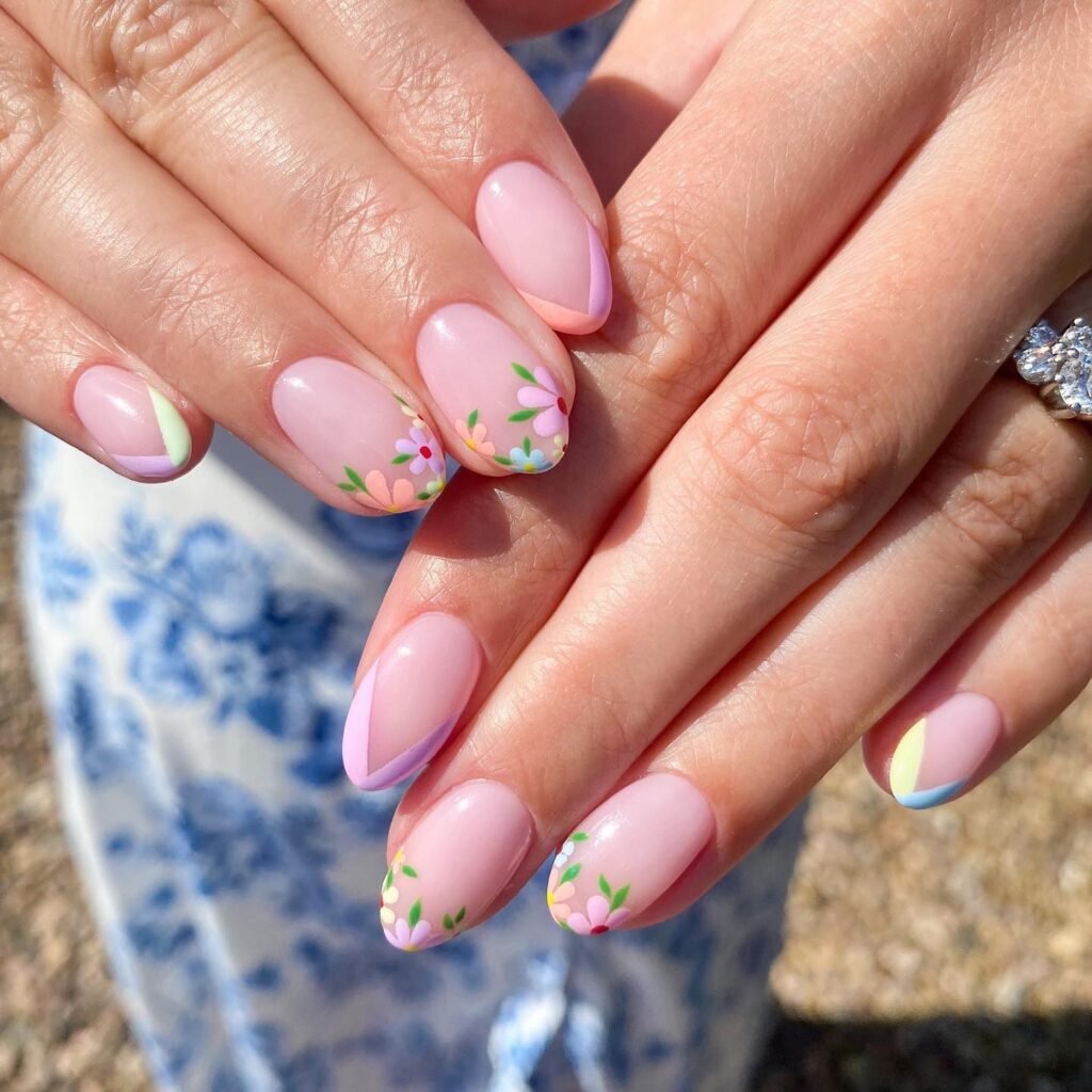 Elegant summer nails with vibrant pink and blue flower designs, featuring acrylic 3D flowers on a glossy white base, perfect for spring and summer fashion.