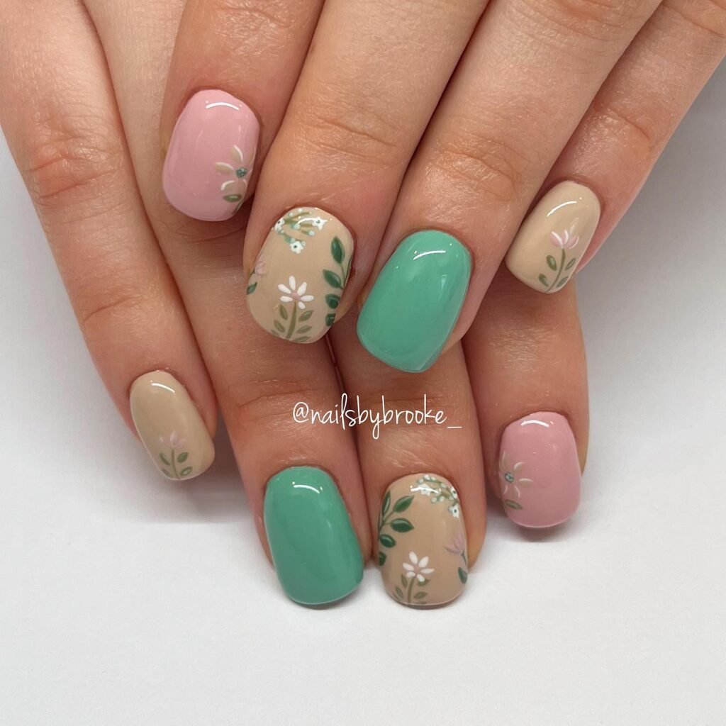 Elegant summer nails with vibrant pink and blue flower designs, featuring acrylic 3D flowers on a glossy white base, perfect for spring and summer fashion.