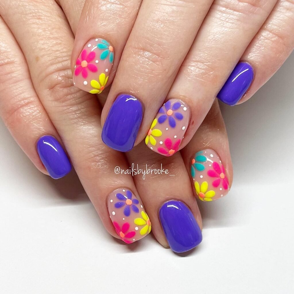 Elegant summer nails with vibrant pink and blue flower designs, featuring acrylic 3D flowers on a glossy white base, perfect for spring and summer fashion.