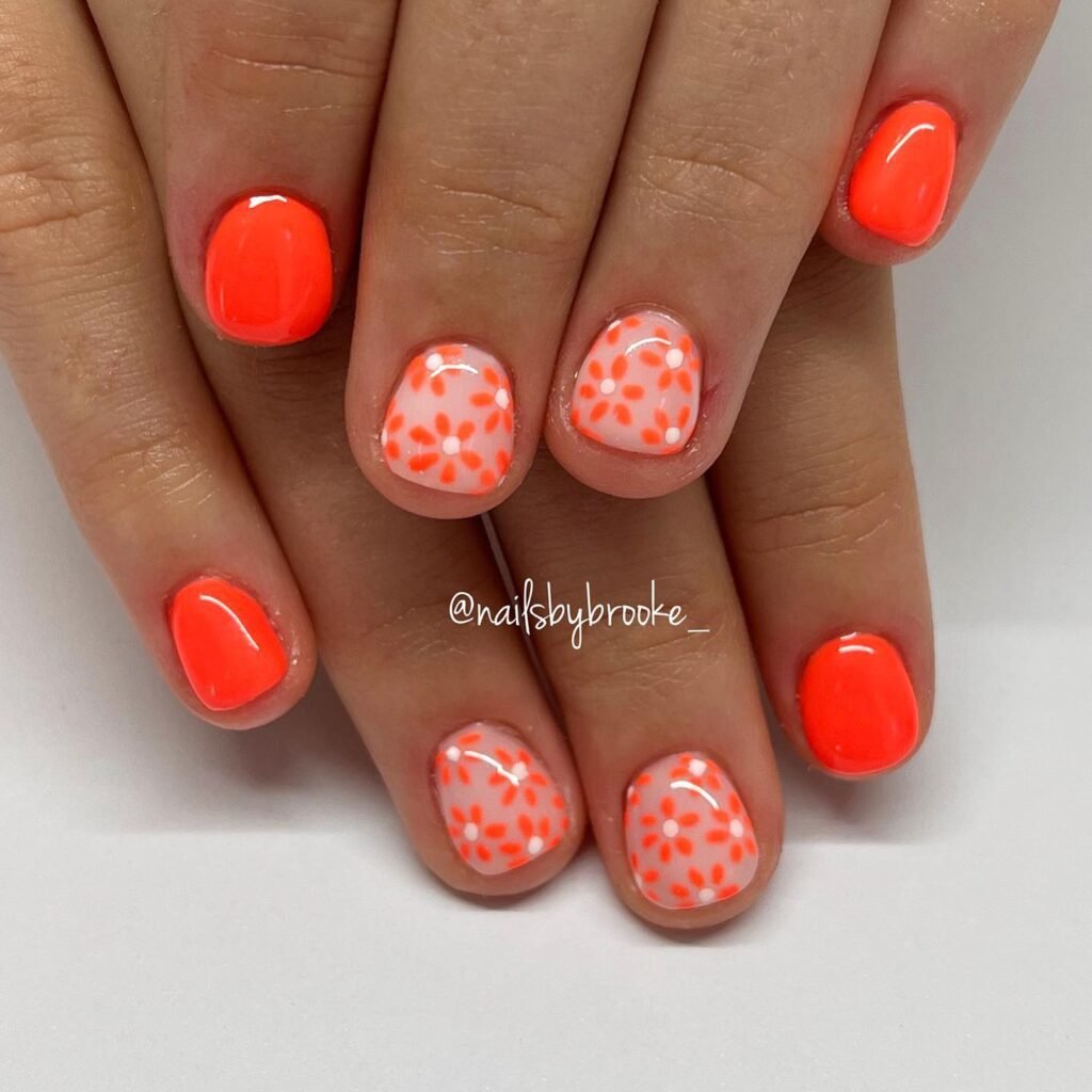 Elegant summer nails with vibrant pink and blue flower designs, featuring acrylic 3D flowers on a glossy white base, perfect for spring and summer fashion.