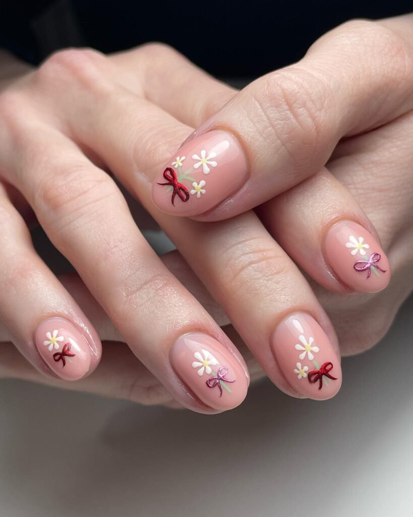 Elegant summer nails with vibrant pink and blue flower designs, featuring acrylic 3D flowers on a glossy white base, perfect for spring and summer fashion.