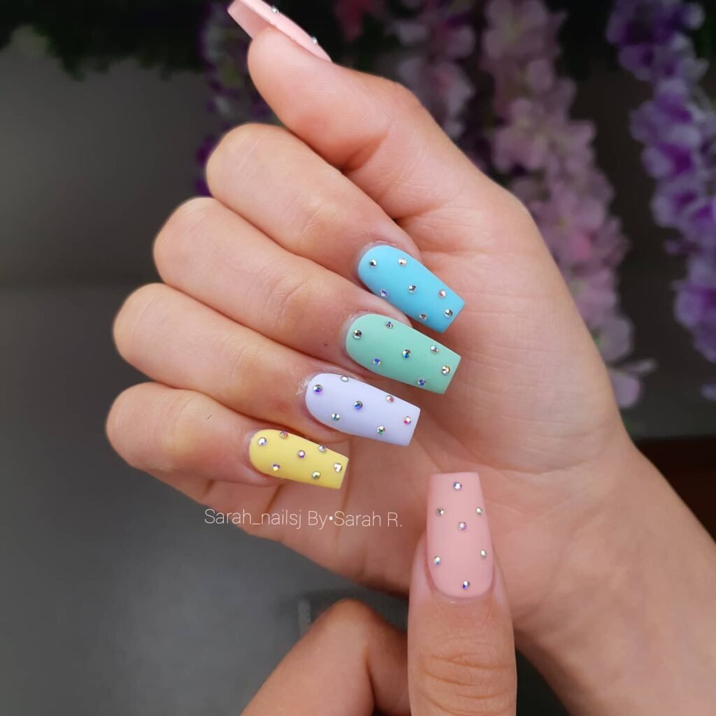Assorted pastel nail designs featuring pastel pink nails, pastel blue, and pastel green acrylic nails perfect for spring and summer